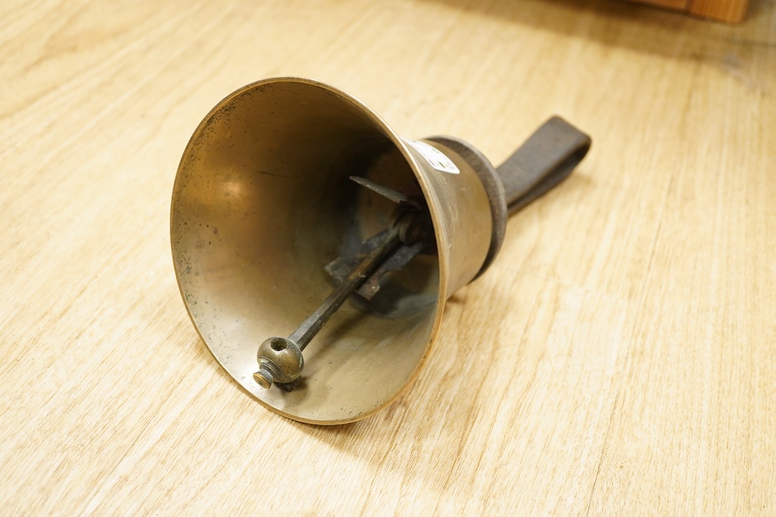 A set of twenty-two bronze handbells by Mears, London, with leather grips, together with two books from the Jasper Snowden Change Ringing Series, largest diameter 16cm